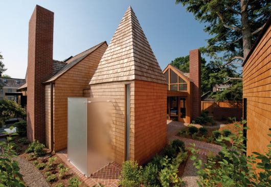 An outdoor shower occupies a nook outside the pool bath.