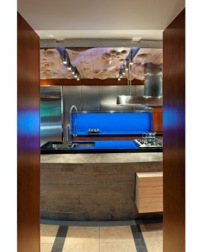 This clean, contemporary kitchen in Omaha features a mix of materials, including stainless steel, cast concrete, cherry, bubinga, and maple.  