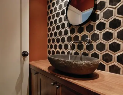 A+wall+to+wall+vanity+houses+below-counter+storage.+The+oval+stone+sink+is+generously+sized.