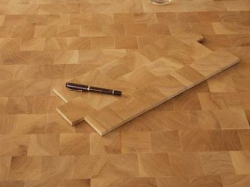 Pave de Paris is an end-grain hardwood flooring imported from France. The pre-finished product can be laid with no nails or glue and instead uses a floating compression system. It comes in rubberwood, French oak, guatambu, iroko, smoked oak, and ashy oak. www.ambbois.com.