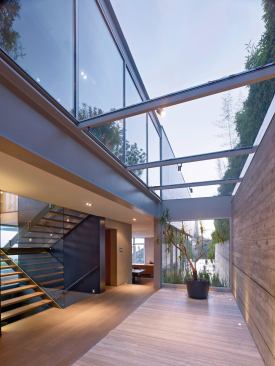 A glass-and-concrete-lined foyer adds drama to the entryway.