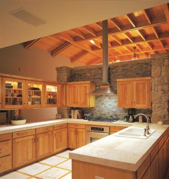 Non-structural walls separate the kitchen, family room, and living and dining area. The stone dividers keep the home's scale from feeling overwhelming while still allowing light and air to flow through the interiors.