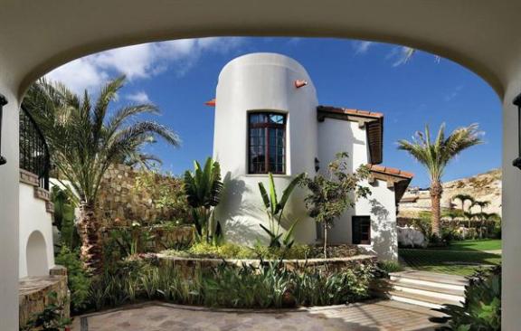Traditional architectural details and tropical landscaping give the home a genuine sense of place. 