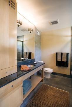 A sink-to-ceiling mirror also helps amplify the opening's natural illumination.