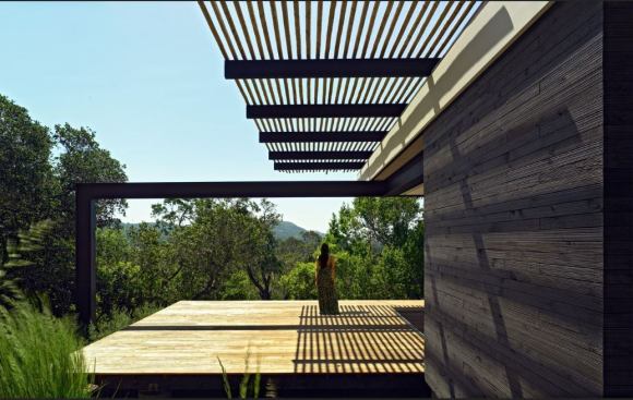 The cedar siding repels water and insects. Much of the building’s yearly electrical load is offset by a photovoltaic array hidden near the bottom of the south slope.