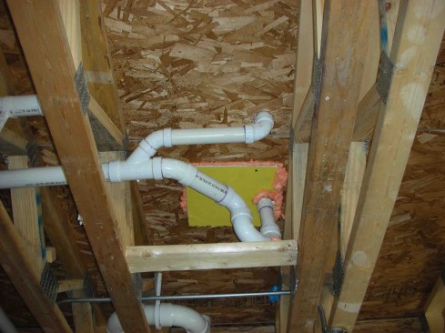 Here, the hole under the tub has been well sealed with rigid sheet material and gun foam.