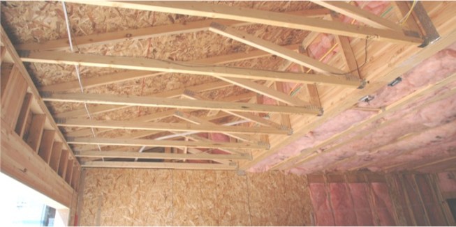 The juncture between a garage roof and an attic space should be sheathed over before the trusses are set.