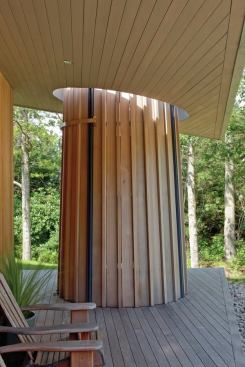 
        The design team wanted the shower to 
read as the strongest part of the porch composition, so they produced a 
circular opening in the porch overhang so the shower stands as an 
uninterrupted form.