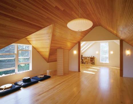 Beaded fir paneling takes center stage in the second-floor studio, where it highlights the angular geometry of the dormered roof.