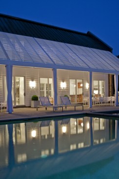 Sliding doors connect first-floor living, an office, and a pool bath to an expansive bluestone deck, the pool, and an integrated spa