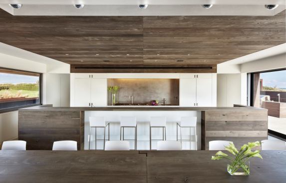 Another wall of sliding doors opens the kitchen and dining room to the beach.