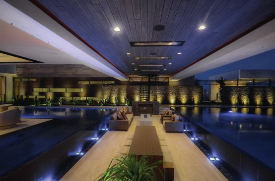 The sunken living room appears to float between two large pools. 