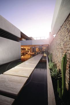 A canal runs along a walkway from the front door.