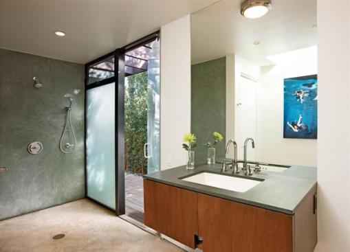 A unique bathroom shower arrangement emphasizes the open plan and indoor-outdoor connection.