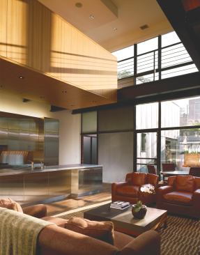 Discrete, box-like volumes clad in elm veneer and stainless steel allow the building’s simple interior geometry to read through.