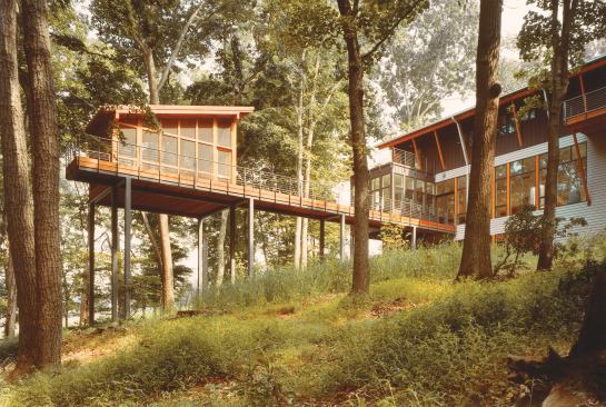 Both the main house and the separate porch take in abundant views of their leafy surroundings.
