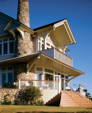 A stone wall encloses the home’s base, keeping the elevated first floor from appearing too high off the ground. An east-facing, ipé-floored porch provides a space for entertaining groups and watching the sun rise.