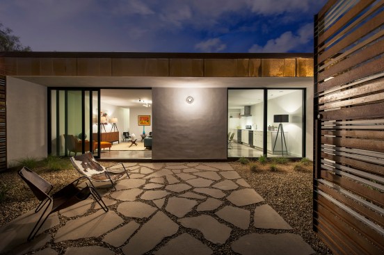 That sexy screen encloses a front courtyard that provides a barrier between living spaces and the street. 