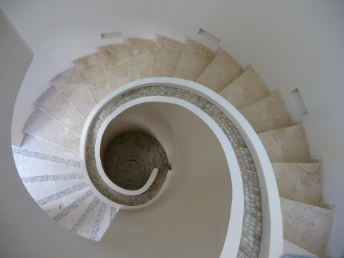 Circular+stair+with+waterfall+at+interior+handrail