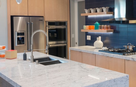 The kitchen in the large contemporary home is made both funky and functional with Danze's industrial-style Parma faucet.