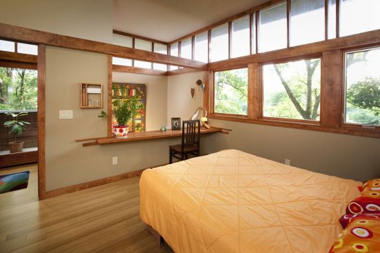 Wood trim of birch or Douglas fir reinforces the linear aesthetic in the master bedroom.