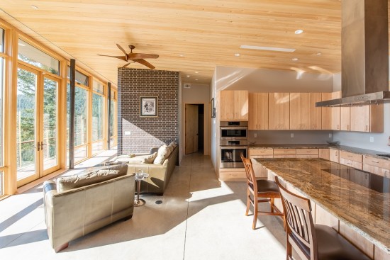 To add warmth to the open living space, the architects balanced the hard masonry materials with Douglas fir pine cabinetry, window framing, and ceilings.