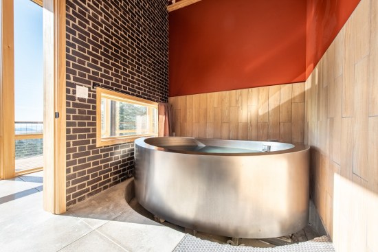 The Japanese onsen, or soaking tub, sits in its own room in the center of the floor plan and has views of the mountains, too.