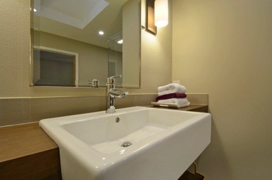 The wheelchair-accessible vanity sink includes sleek paddle handles. 