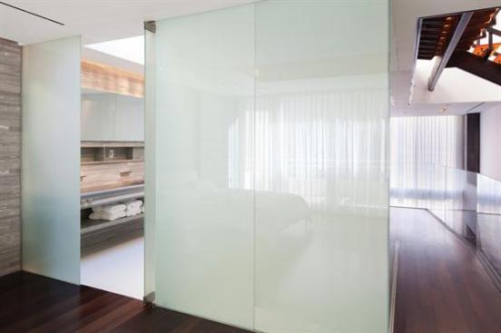 Luxury+touches+like+a+stone+wall+wth+faucets+embedded+in+it+and+a+custom+vanity+work+in+concert+wtih+the+privacy+glass+for+a+deluxe%2c+space-age+effect.