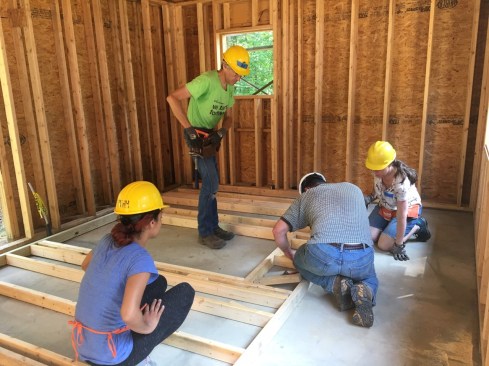 Habitat for Humanity volunteers frame up the interior of a double-stud-wall unit.
