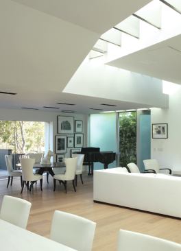 The pathway subtly divides the loftlike interior into kitchen, living, and dining spaces. 