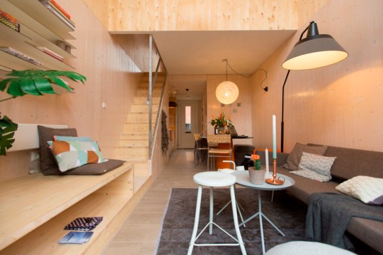 The home's interior uses natural materials and light colors to create a sense of space.