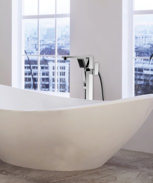 Contemporary oval ceramic bathtub and houseplants in a spacious airy loft conversion bathroom with tall windows overlooking a cityscape. 3d rendering