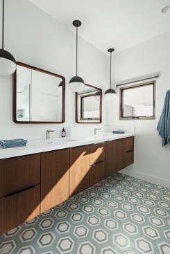 Sphere accent lights, rounded-corner mirrors, and hexagonal cement tile add personality to the master bathroom.
