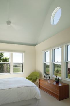 A bedroom takes in farmland views.