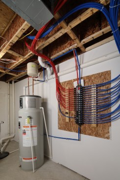 A sophisticated manifold saves both water and energy. Construction photos courtesy of Alter Eco, LLC.