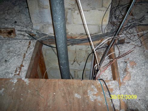 This attic space has a combination of improper insulation, and poor sealing of venting penetrations and chaseway, Robinette says.