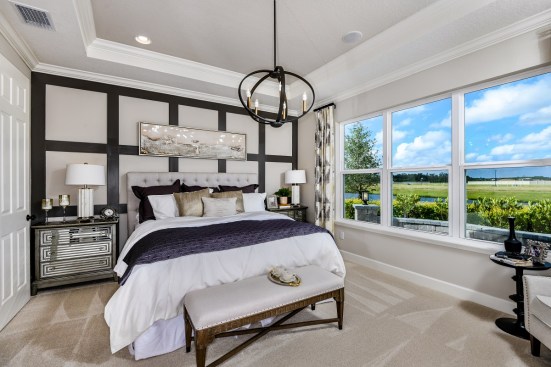 Homes in Taylor Morrison’s Eave’s Bend, in the master plan of Artisan Lakes in Palmetto, Florida, include luxurious owner’s suites as well as flex space upgrades.