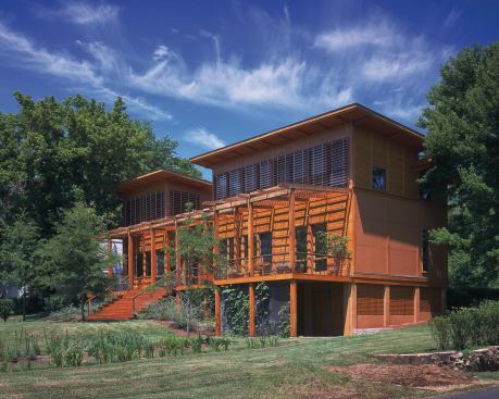 PASSIVE SOLAR AND DAYLIGHTING A key strategy for reducing energy use was to locate common areas and bedrooms on the south side to take advantage of daylight and warmth. Deep overhangs, louvers, a trellis, and deciduous trees shade the large southwest-facing windows. The louvers horizontal slats are angled to deflect direct summer sun but allow solar penetration in winter, based on a design formula that optimizes their shading performance. The Duratherm custom windows are made of FSC-certified Spanish cedar. Their double-pane glazing has a 70% visible light transmittance, an SHGC of 0.36 and a U-value between 0.29 and 0.26. 800.996.5558. 
www.durathermwindow.com.