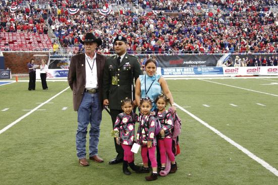 Recognizing True Heroes: Dan Wallrath (left), a 30-year home building veteran and founder of Operation Finally Home, with Corporal Hugo Gonzalez and his family. Gonzalez was wounded while serving in Baquba, Iraq. Operation Finally Home used the Armed Services Bowl football game in 2010 to announce it was giving the family a new home, mortgage free.