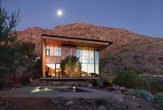 The Jarson Residence employs a simple gesture—a folded plane of rusted steel that forms one wall and the roof—to create a powerful sense of shelter.