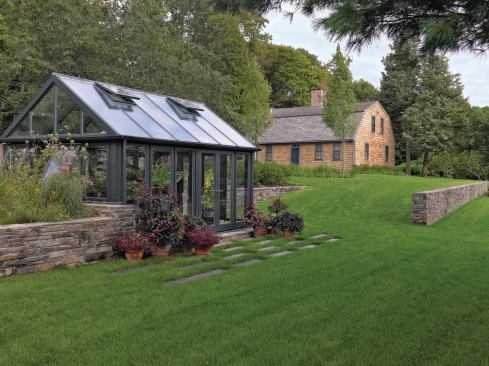 Awning windows and skylights regulate the greenhouse's interior temperature.


