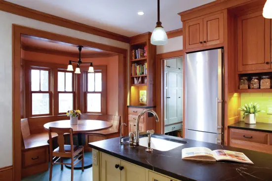 The owners wanted an eating nook in the kitchen, as well as easy access to the fridge. Because wall space was at a premium, two tall skinny fridges were positioned on either side of the working island. 