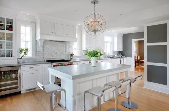 After: The new expansive kitchen flows forth from the old kitchen (the old kitchen occupied the space on the far right where the sink is) and bridges the dining room and the family room while respecting the home's architecture.