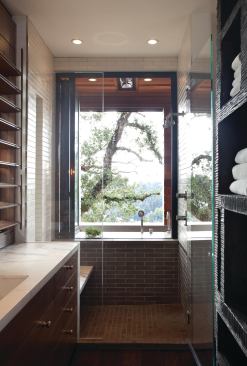 Like much of the house, the master bathroom extends to the outdoors, with an indoor shower connected to an outside tub via Nanawall glass sliders.