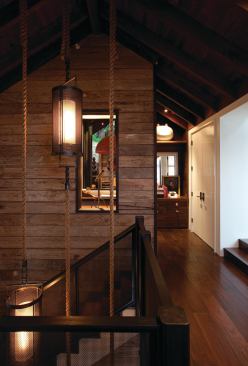 Rather than discarding scaffolding deemed unusable per new OSHA standards, designer Erin Martin repurposed them for the stairway walls. The flooring--a black walnut veneer with an engineered plywood substrate, was obtained from within 500 miles.