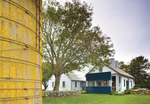 The addition's black panels are a counterpoint to the historic window forms.