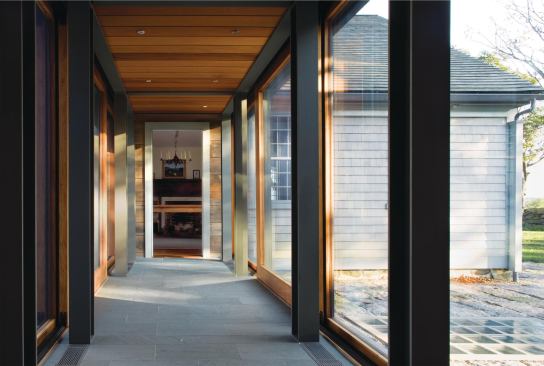 To the right of the glass walkway, a ground-level skylight illuminates the restored cistern beneath. Lit at night, it emits a soft glow.

