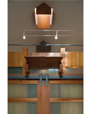 The bathroom, built like a piece of fine furniture, is brightened by a chimney skylight.

