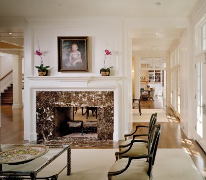 The walls of windows, double-sided glass cabinets, and framed views into other rooms that enrich this Glencoe, Ill., house appear throughout the firm's work. The architects tucked the home's entry into a corner niche, sheltering it from the elements.